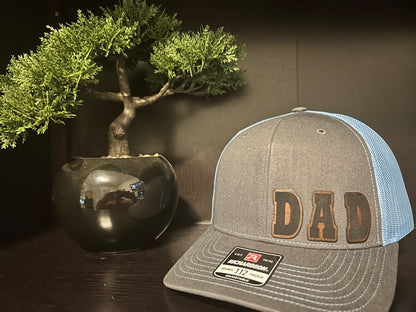 “D A D" custom leather patch on Trucker Hat Charcoal/Columbia Blue